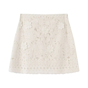 Flat lay of detailed white floral lace skirt with intricate hollow mesh texture