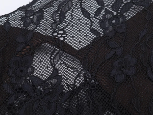 Close-up of elegant black floral lace embroidery and mesh texture on the satin dress
