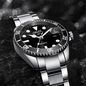 Macro detail of silver stainless steel watch dial with black bezel on dark rock