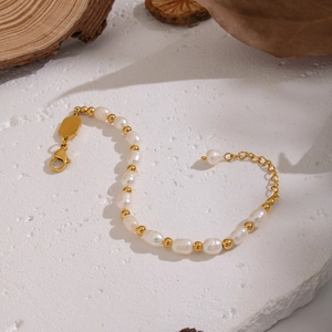 Elegant baroque freshwater pearl bracelet with gold stainless steel beads on stone base