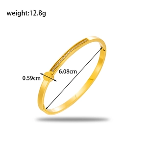 Polished gold stainless steel bangle with inlaid diamonds and 6.08cm inner diameter