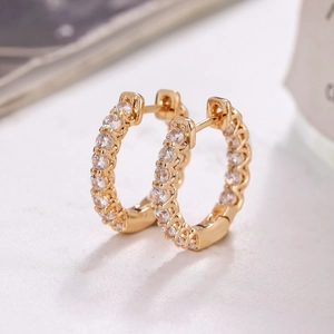 Elegant gold hoop earrings featuring micro-pave white cubic zirconia on a minimalist design