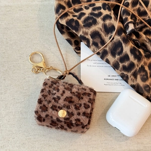Detail shot of leopard faux fur mini pouch with gold snap and carabiner clip