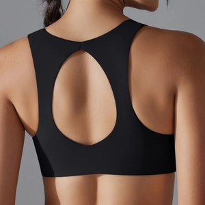 Close-up of the breathable teardrop cutout design on the back of this black sports bra