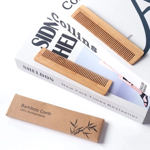 Detail of eco-friendly bamboo comb with 100% biodegradable kraft paper packaging