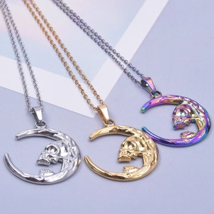 Three celestial moon and skull necklaces in silver, gold, and rainbow metallic finishes