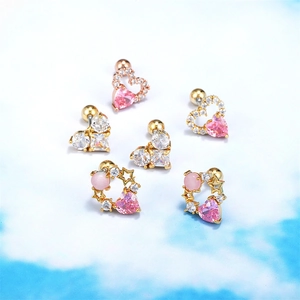 Detailed view of pink heart earrings with gold alloy and sparkling zircon stones
