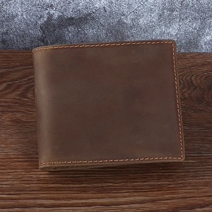 Retro dark brown crazy horse leather men's short wallet on rustic wood and concrete background