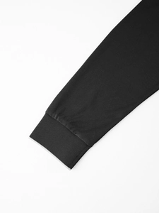 Detailed close-up of black business polo shirt featuring ribbed knit cuffs and stitching