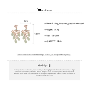 Detailed view of vintage-style ginkgo leaf earrings with tassels and size dimensions