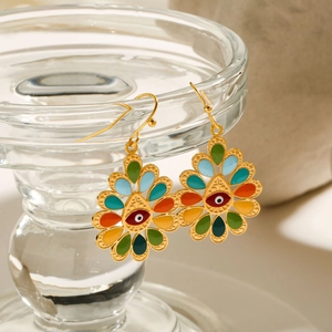 Macro detail of Bohemian enamel drop earrings with Evil Eye design in gold finish
