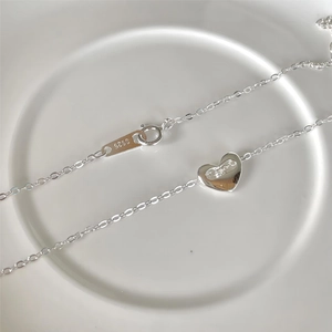 Close-up of S925 sterling silver heart pendant necklace with hallmark on fine chain