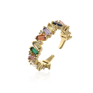 Close-up of gold plated rainbow baguette zircon ring with adjustable open band design