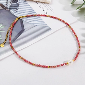 Faceted rhodochrosite bead necklace with a large white pearl and gold heart pendant