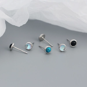 Detailed view of S925 sterling silver studs with turquoise, opal, and black agate stones