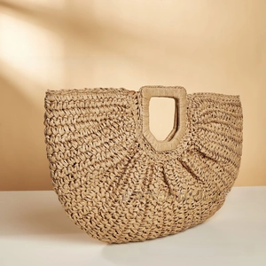 Detailed close-up showing the intricate woven texture of this beige straw tote beach bag