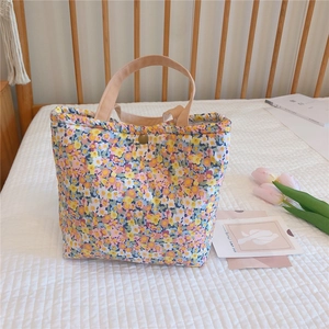 Detailed shot of floral cotton lunch bag with copper snap button and wide handle