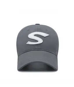 Detailed view of grey baseball cap featuring white 3D embroidered S logo on the front