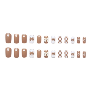 Cute brown and white press-on nails with cartoon bear, bow, and checkerboard patterns