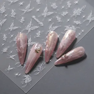 3D embossed white butterfly nail stickers with floral patterns on pink gradient nails