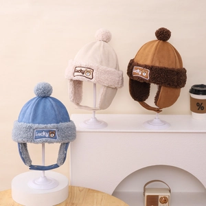 Detail showing plush earflaps and Lucky bear patch on colorful winter pilot hats