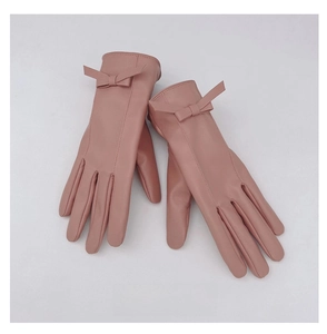 Dettaglio guanti rosa in ecopelle con fiocco e calda fodera in pile per donna invernale