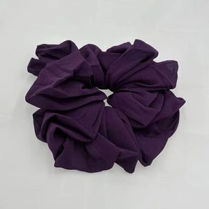 Close-up of soft purple chiffon scrunchie with elastic band and premium fabric texture