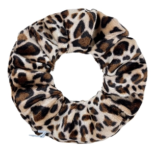 Close-up of leopard print velvet scrunchie with soft plush texture and zipper detail