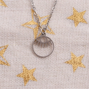 Silver stainless steel Evil Eye necklace with hollow round pendant on star cloth background