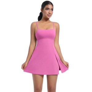 Detail of hot pink athletic dress featuring a side slit and breathable stretch fabric