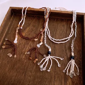 Ethnic bohemian layered beaded necklace with irregular glass stones and tassel charms