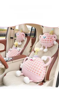 Detail of pink cartoon car headrest with soft waffle plush texture and cute design