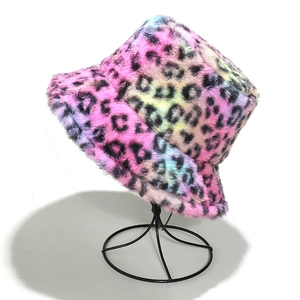 Close-up of a colorful leopard print bucket hat made of soft faux fur on a metal stand