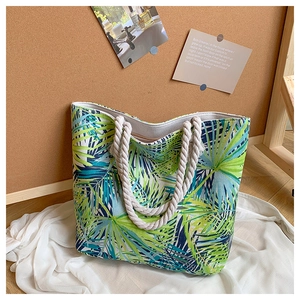 Detail of tropical palm leaf print canvas tote with white cotton rope handles