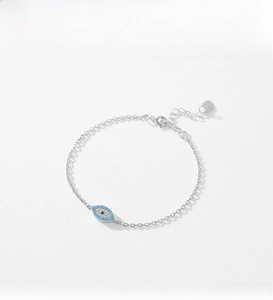 Detailed close-up of S925 silver evil eye bracelet with blue and white crystals