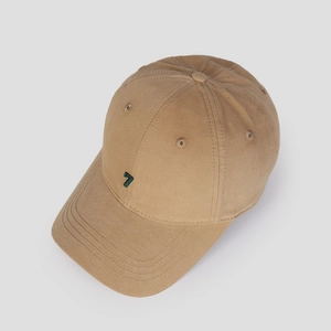 Detail of khaki cotton baseball cap showing green number 7 embroidery and twill texture