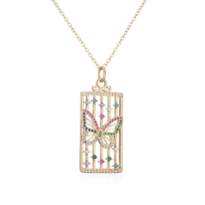 Macro shot of 18K gold plated necklace featuring a detailed butterfly cage pendant
