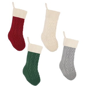 Classic cable knit Christmas stockings in red, white, green and grey on white background