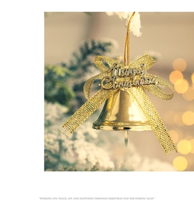 Detail of golden Christmas bell ornament with Merry Christmas tag and mesh bow decoration