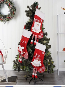 Close-up of three plush Christmas stockings with 3D characters hanging on a tree