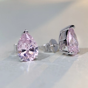 Macro view of pear-cut pink high-carbon diamond earrings with classic S925 claw setting