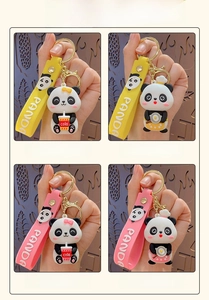 Detail showing cartoon panda keychains with PANDA embossed straps and gold metal hooks