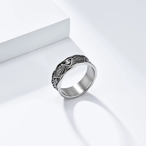 Detail of vintage silver Eye of Horus ring with geometric engraving on white podium