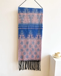 Detail of blue and pink geometric polka dot scarf with black decorative fringes