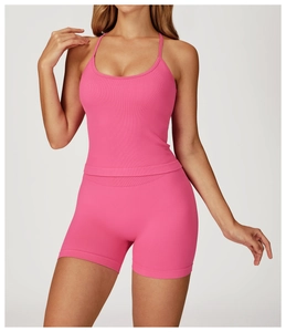 Close-up of ribbed texture on rose pink yoga vest and high-waisted fitness shorts