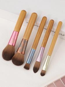 Detail of 5-piece makeup brush set featuring bamboo handles and floral patterned ferrules