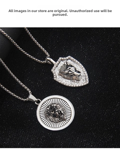 Detailed close-up of retro lion and wolf head pendants with sparkling crystal inlay