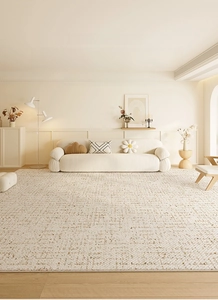 Close-up of cream woven rug with brown grid pattern in a modern living room setting