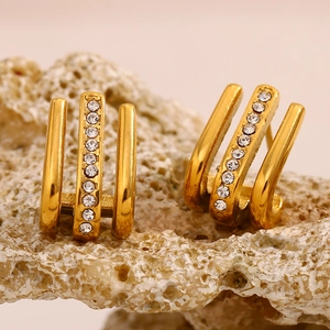 Detailed macro view of 18K gold-plated triple-row J-hook earrings with sparkling crystals