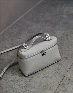 Detailed top view of light grey pebble grain leather handbag with silver hardware details